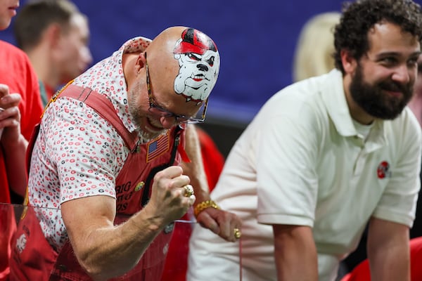 Georgia fan Mike Woods Jr. (left, celebrating at the SEC championship game) is ready for another ring.