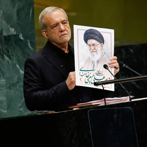 Iran's President Masoud Pezeshkian holds an image of late Iranian Supreme Leader Ayatollah Ali Khamenei during the 81st session of the United Nations General Assembly at United Nations headquarters, Wednesday, Sept. 23, 2026. (AP Photo/Stefan Jeremiah)
