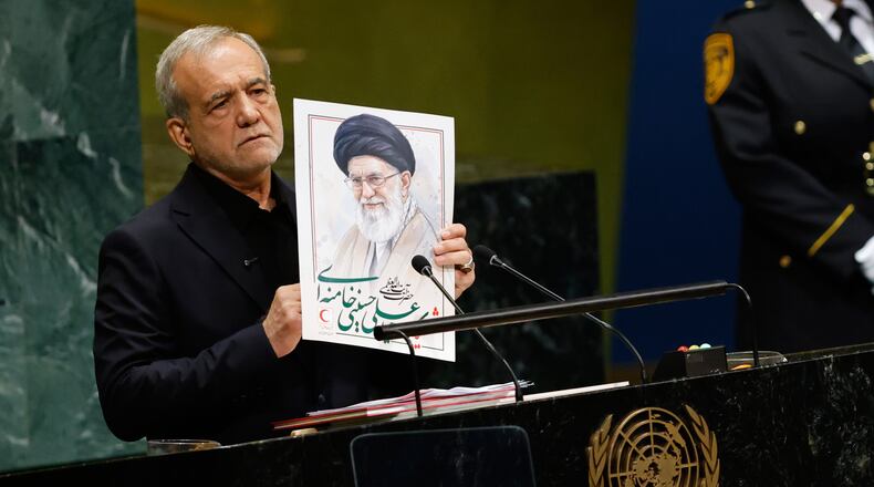 Iran's President Masoud Pezeshkian holds an image of late Iranian Supreme Leader Ayatollah Ali Khamenei during the 81st session of the United Nations General Assembly at United Nations headquarters, Wednesday, Sept. 23, 2026. (AP Photo/Stefan Jeremiah)