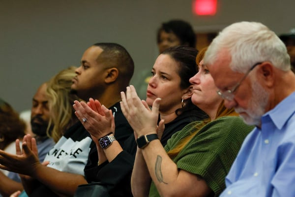 A member of the audience applauds during a town hall meeting hosted by U.S. Sen. Raphael Warnock, D-Ga., at Zion Hill Baptist Church on Sunday, May 4, 2025. 
(Miguel Martinez/ AJC)