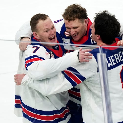FILE - United States' Brady Tkachuk (7), Matthew Tkachuk, center, and Zach Werenski (8) celebrate after their overtime win against Canada in the men's ice hockey gold medal game at the 2026 Winter Olympics in Milan on Feb. 22, 2026. (AP Photo/Carolyn Kaster, File)