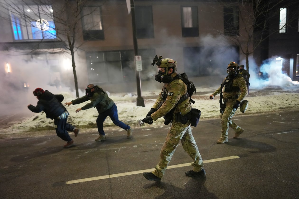 Federal agents try to clear demonstrators near a hotel, using tear gas during a noise demonstration protest in response to federal immigration enforcement operations in the city Sunday, Jan. 25, 2026, in Minneapolis, Minn. (Adam Gray/AP)