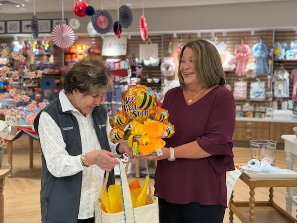 Corky Bowers (left), a gift shop volunteer, looks over gifts with Amy Saye, the director of volunteers and patient advocates at Wellstar Health System. (Courtesy of Wellstar Health System)