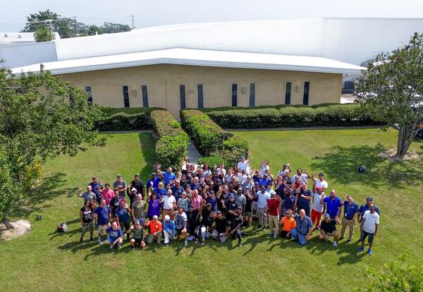 Blue Ops employees stand outside the company's Valdosta manufacturing facility, where the company assembled autonomous marine boats. (Courtesy of Blue Ops)