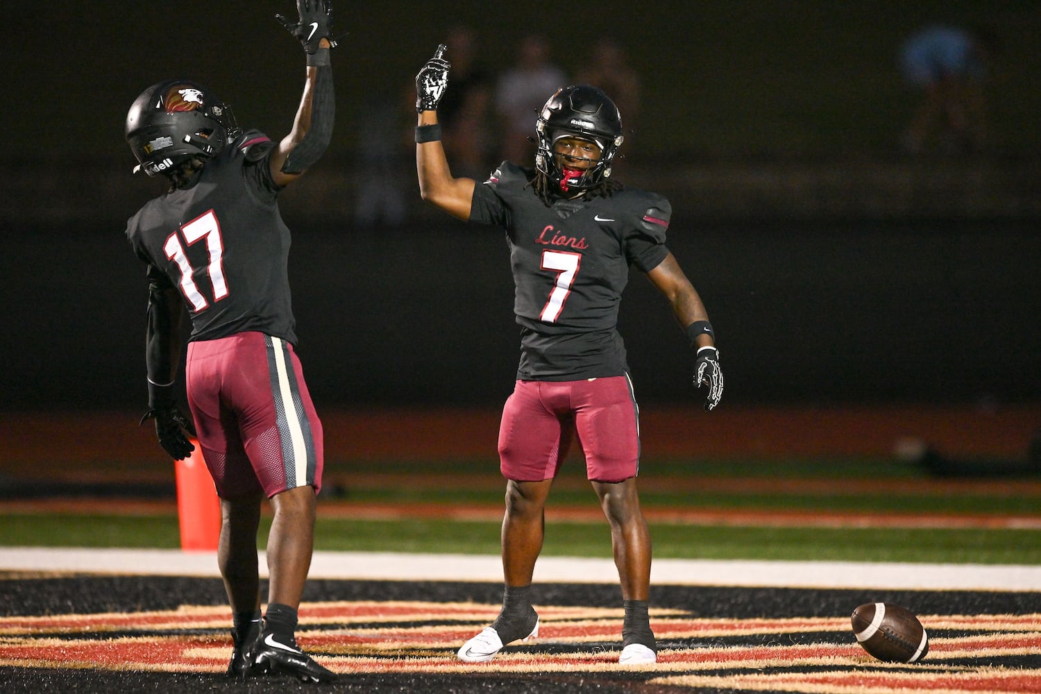 Hebron’s Jarvis Mathurin (right) celebrates his touchdown with Devon Caldwell during the first half of play Friday, Sept. 26, 2025 at Hebron Christian Academy. (Daniel Varnado for the AJC)