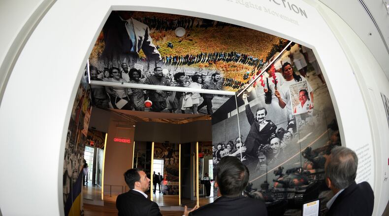 National Center for Civil and Human Rights CEO Doug Shipman, left, explains exhibits on the third floor during a walk-through Tuesday, June 10, 2014, in Atlanta. The NCCHR tells a story broader than the American civil rights movement, linking that movement to the international current of human rights reform that took inspiration in Atlanta. David Tulis / AJC Special