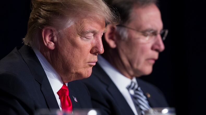 President Donald Trump and Sen. John Boozman, R-Ark., pause during the National Prayer Breakfast earlier this year. AP /Evan Vucci