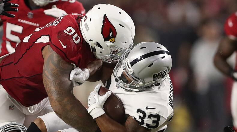 GLENDALE, AZ - AUGUST 12:  Defensive tackle Robert Nkemdiche #90 of the Arizona Cardinals tackles running back DeAndre Washington #33 of the Oakland Raiders for a loss during the second half of the NFL game at the University of Phoenix Stadium on August 12, 2017 in Glendale, Arizona. The Cardinals defeated the Raiders 20-10. (Photo by Christian Petersen/Getty Images)