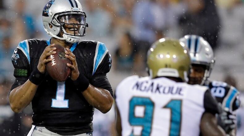 Carolina Panthers quarterback Cam Newton (1) looks for a receiver as he is rushed by Jacksonville Jaguars defensive end Yannick Ngakoue (91) during the first half of an NFL preseason football game, Thursday, Aug. 24, 2017, in Jacksonville, Fla. (AP Photo/John Raoux)