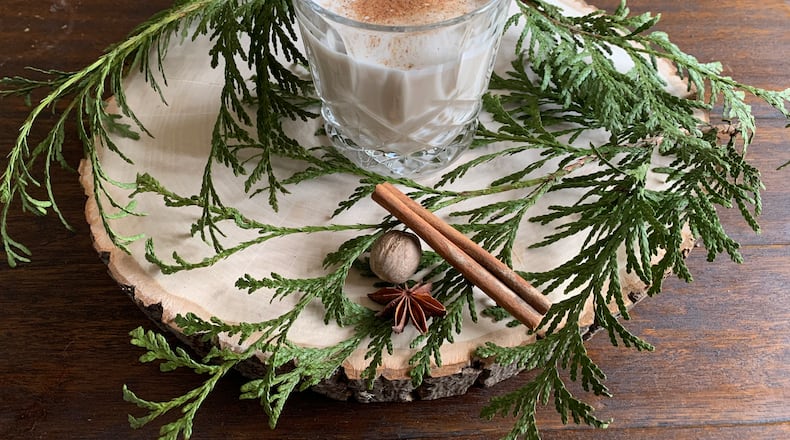 Mixing some coquito at home is quick and easy; just pop open a few cans and sprinkle in spices. Angela Hansberger for The Atlanta Journal-Constitution