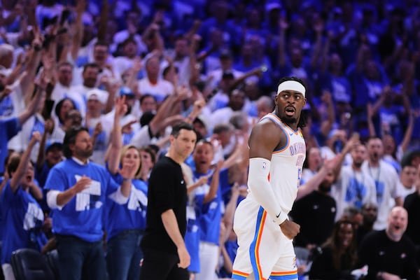 Fans cheer as Oklahoma City Thunder's Luguentz Dort celebrates sinking a three-pointer in the second half of Game 5 of an NBA basketball second-round playoff series against the Denver Nuggets Tuesday, May 13, 2025, in Oklahoma City. (AP Photo/Nate Billings)