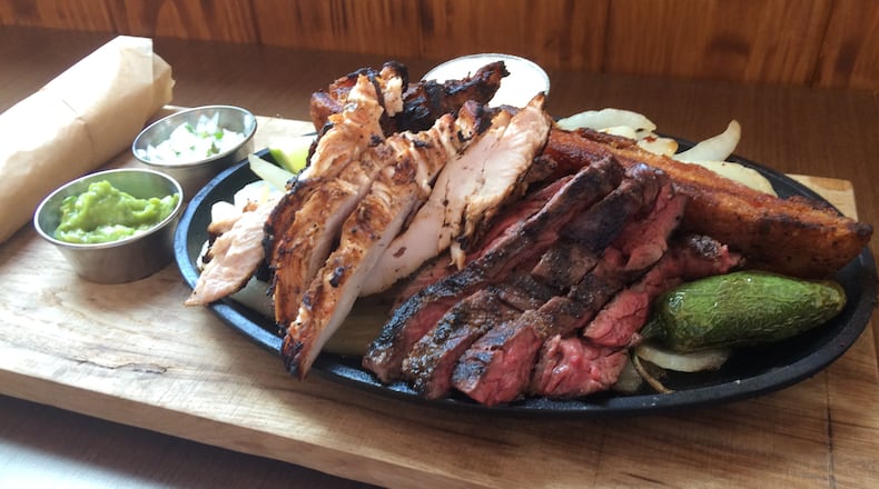 The Parilla Mixta Fajita at Superica includes beef and chicken fajitas, carnitas, guacamole, smoked onion salsa fresca, Mexican butter and house-made flour tortilllas. Photo: Ligaya Figueras