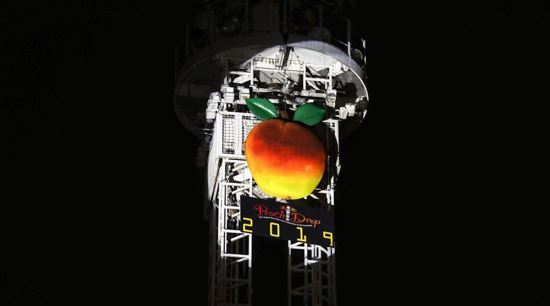 The peach used during the New Years Eve Peach Drop sits perched atop a tower as the festivities are underway at Underground Atlanta, Monday, Dec. 31, 2018. (ALYSSA POINTER/ALYSSA.POINTER@AJC.COM)