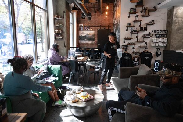 Shanise McGill helps customers at Brooklyn Tea, Friday, Oct. 11, 2024, in Atlanta. (Hyosub Shin / AJC)