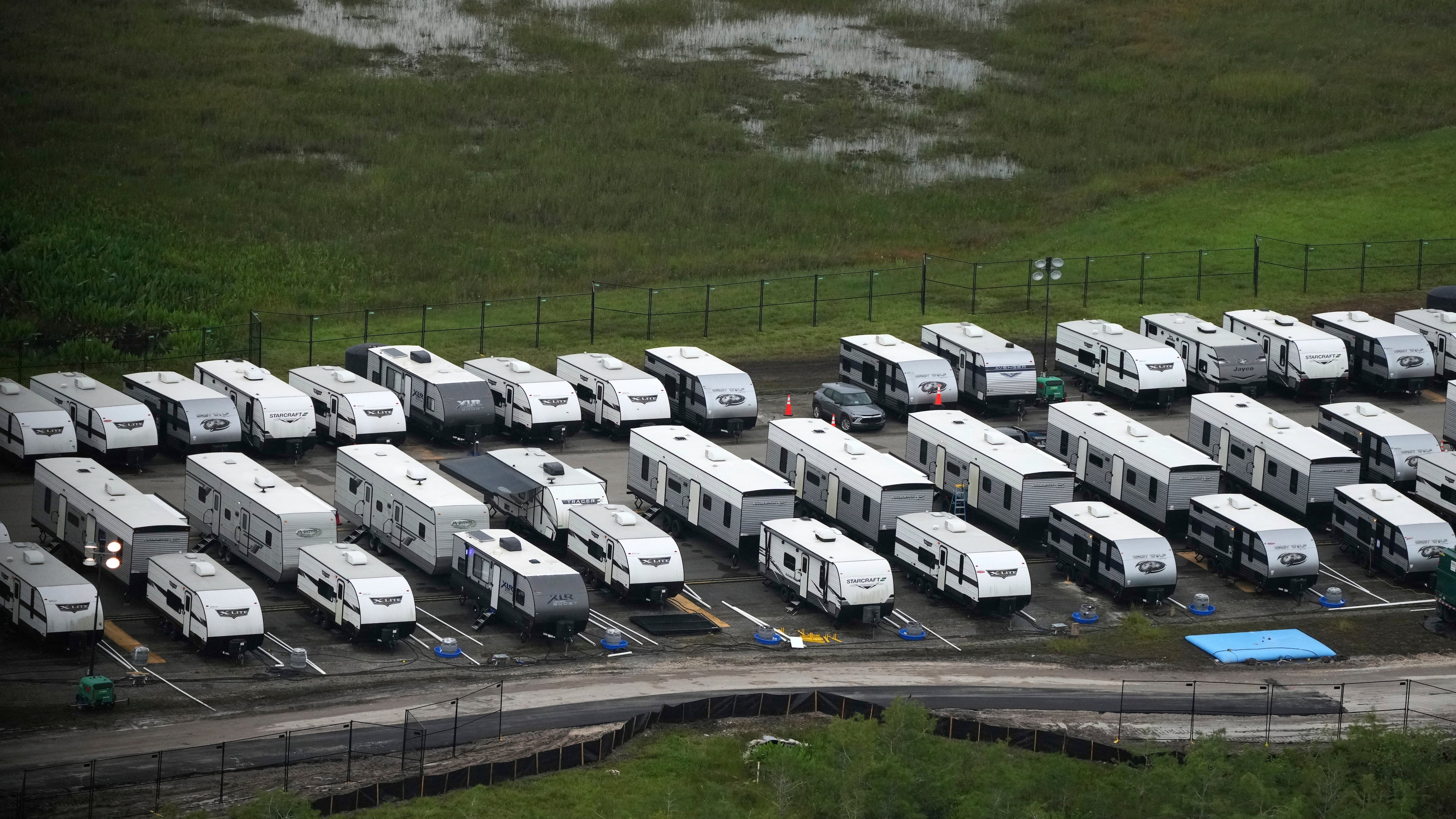 FILE - Trailers sit parked in lines as work progresses on a migrant detention center at Dade-Collier Training and Transition facility in the Florida Everglades, July 4, 2025, in Ochopee, Fla. (AP Photo/Rebecca Blackwell, file)