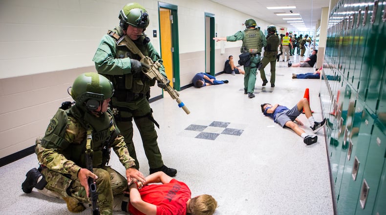 SWAT officers work to secure a hallway during an active shooter drill at Creekview High School in Canton, Ga., on Thursday, July 11, 2019.