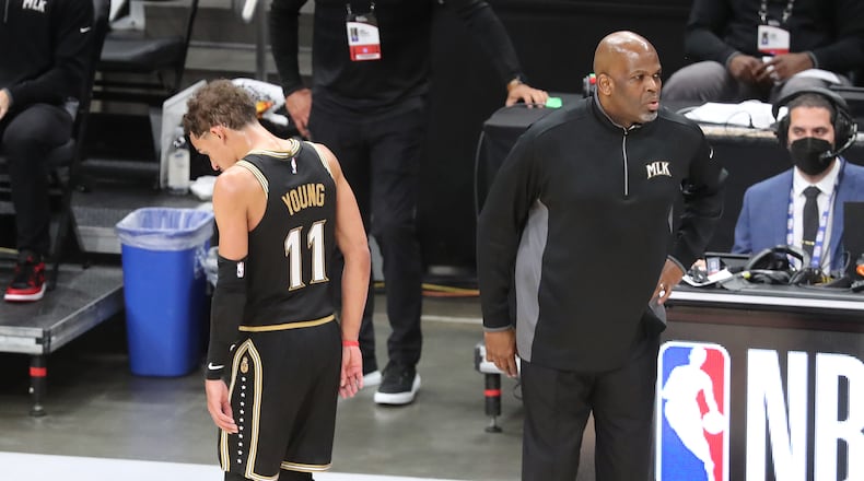 070321 Atlanta: -- NICE JESTURE -- With thirty nine seconds remaining interim head coach Nate McMillan pulls his players, last but not least Trae Young, Atlanta Hawks as the season comes to an end falling to the Milwaukee Bucks in game 6 of the NBA Eastern Conference Finals on Saturday, July 3, 2021, in Atlanta. “Curtis Compton / Curtis.Compton@ajc.com”