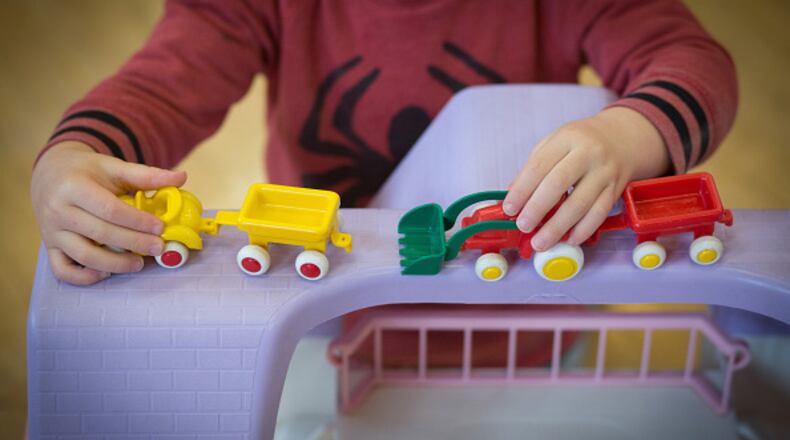 RADSTOCK, UNITED KINGDOM - JANUARY 06: A young boy plays with toys at a playgroup for pre-school aged children in Chilcompton near Radstock on January 6, 2015 in Somerset, England. Along with the health and the economy, education and childcare are to be key issues in the forthcoming election. (Photo by Matt Cardy/Getty Images)