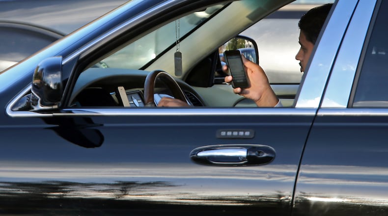 Georgia new distracted driving law takes effect July 1. JASON GETZ / JGETZ@AJC.COM