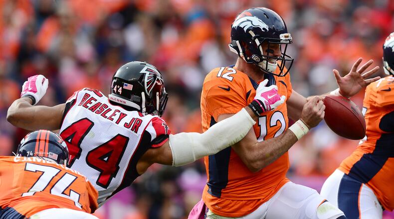 Denver quarterback Paxton Lynch is under pressure from the Falcons’ Vic Beasley on Sunday. (Photo by Dustin Bradford/Getty Images)
