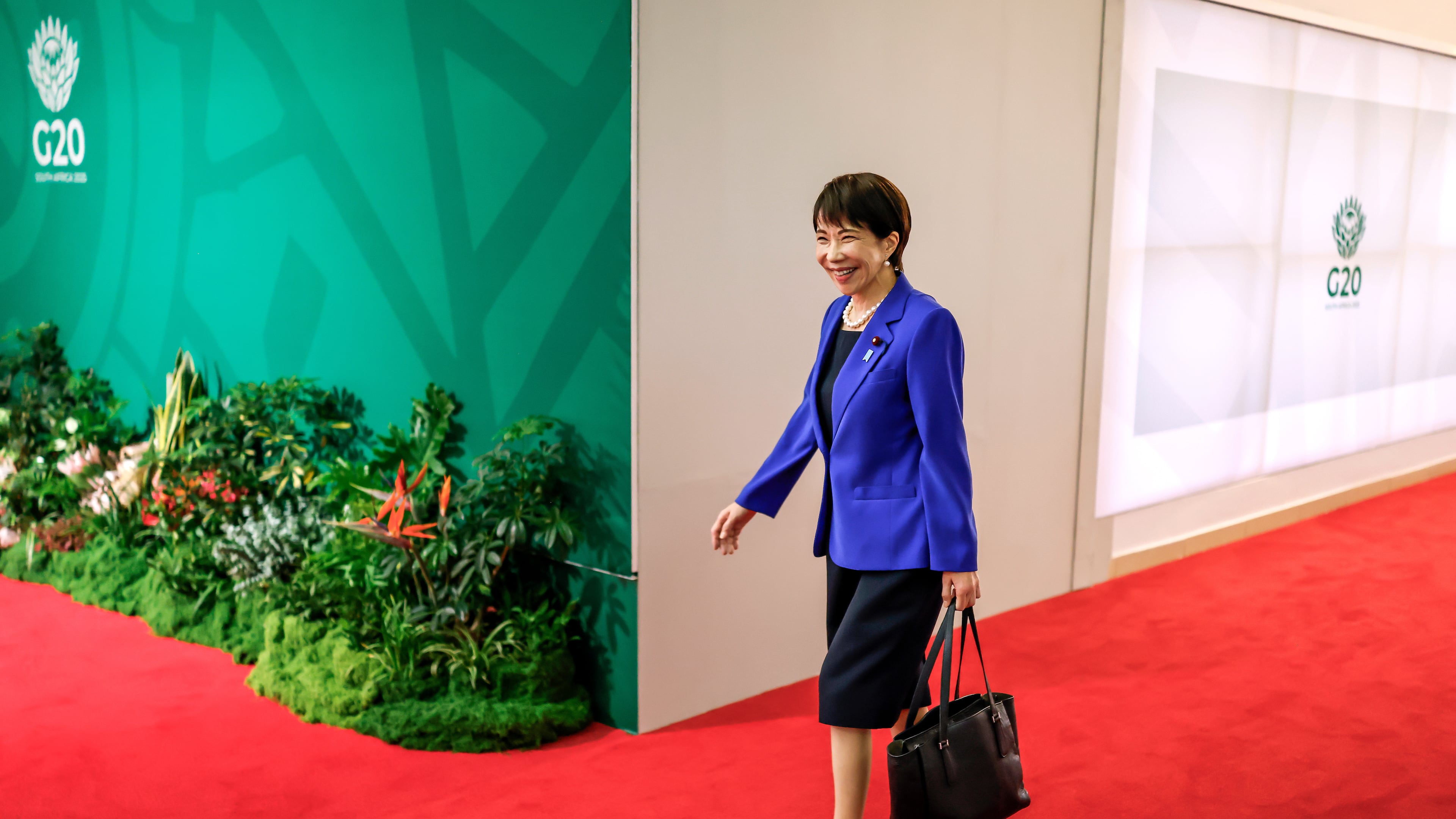 Japan's Prime Minister Sanae Takaichi arrives for the second day of the G20 Leaders' Summit, in Johannesburg, South Africa, Sunday, Nov. 23, 2025. (Marco Longari/Pool Photo via AP)