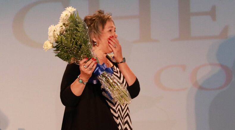 Cheryl Wagnon, receiving a trophy at the Celebrating Nurses Excellence Awards Tuesday, is shocked when she sees her daughter, Katie, who has flown in from Shanghai, China, show up on stage for the event. Photo: Cindy Harter Photography