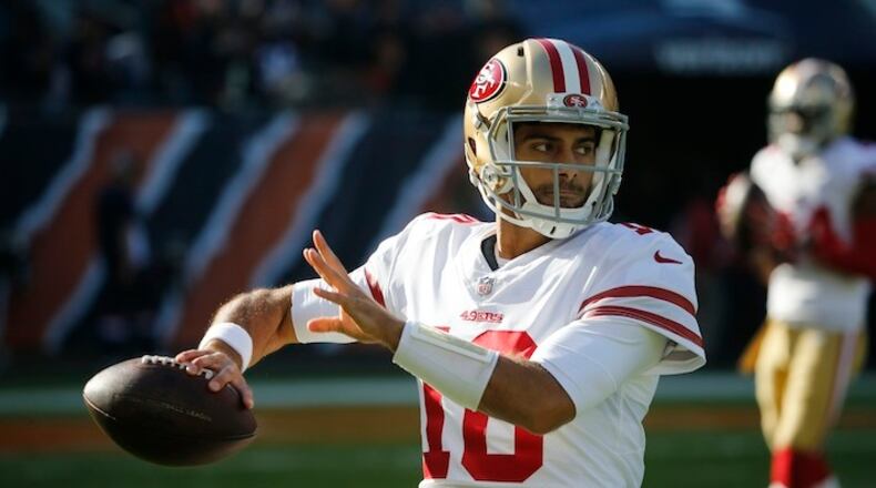San Francisco 49ers quarterback Jimmy Garoppolo (10) warms up before an NFL football game against the Chicago Bears, Sunday, Dec. 3, 2017, in Chicago. (AP Photo/Charles Rex Arbogast)