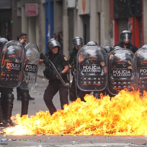 A Molotov cocktail bursts into flames in front of police during a march by unions and opposition supporters against a labor reform bill proposed by President Javier Milei's government in Buenos Aires, Argentina, Wednesday, Feb. 11, 2026.(AP Photo/Rodrigo Abd)