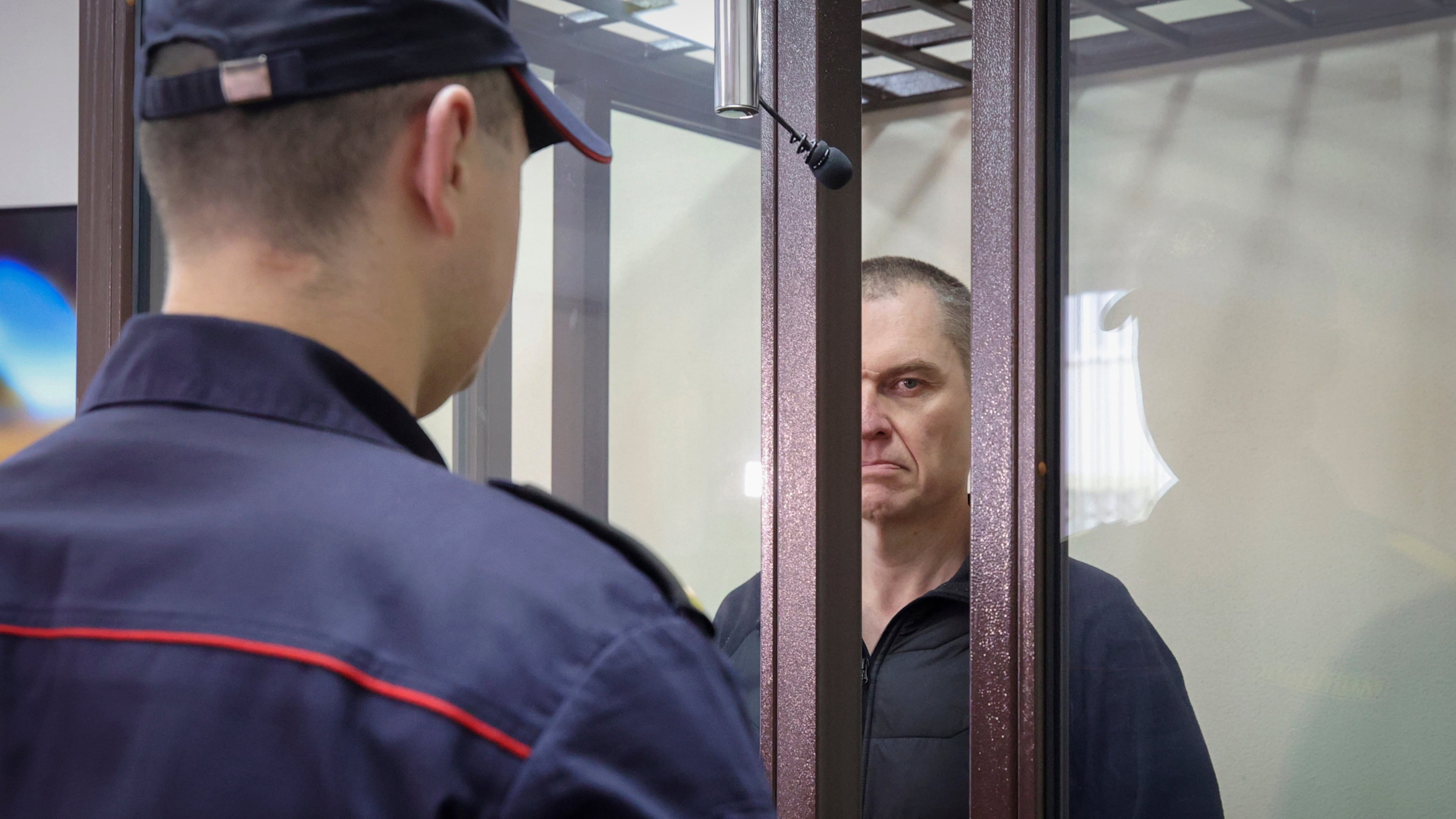 FILE -Journalist Andrzej Poczobut stands in a defendants' cage during a court session in Grodno, Belarus, Jan. 16, 2023. (Leonid Shcheglov/Pool via AP, File)