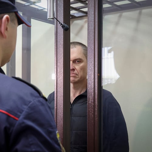 FILE -Journalist Andrzej Poczobut stands in a defendants' cage during a court session in Grodno, Belarus, Jan. 16, 2023. (Leonid Shcheglov/Pool via AP, File)