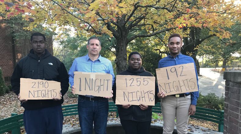 Ben Deutsch with youth involved in Covenant House Georgia's programs. They're holding signs showing how long they were homeless.