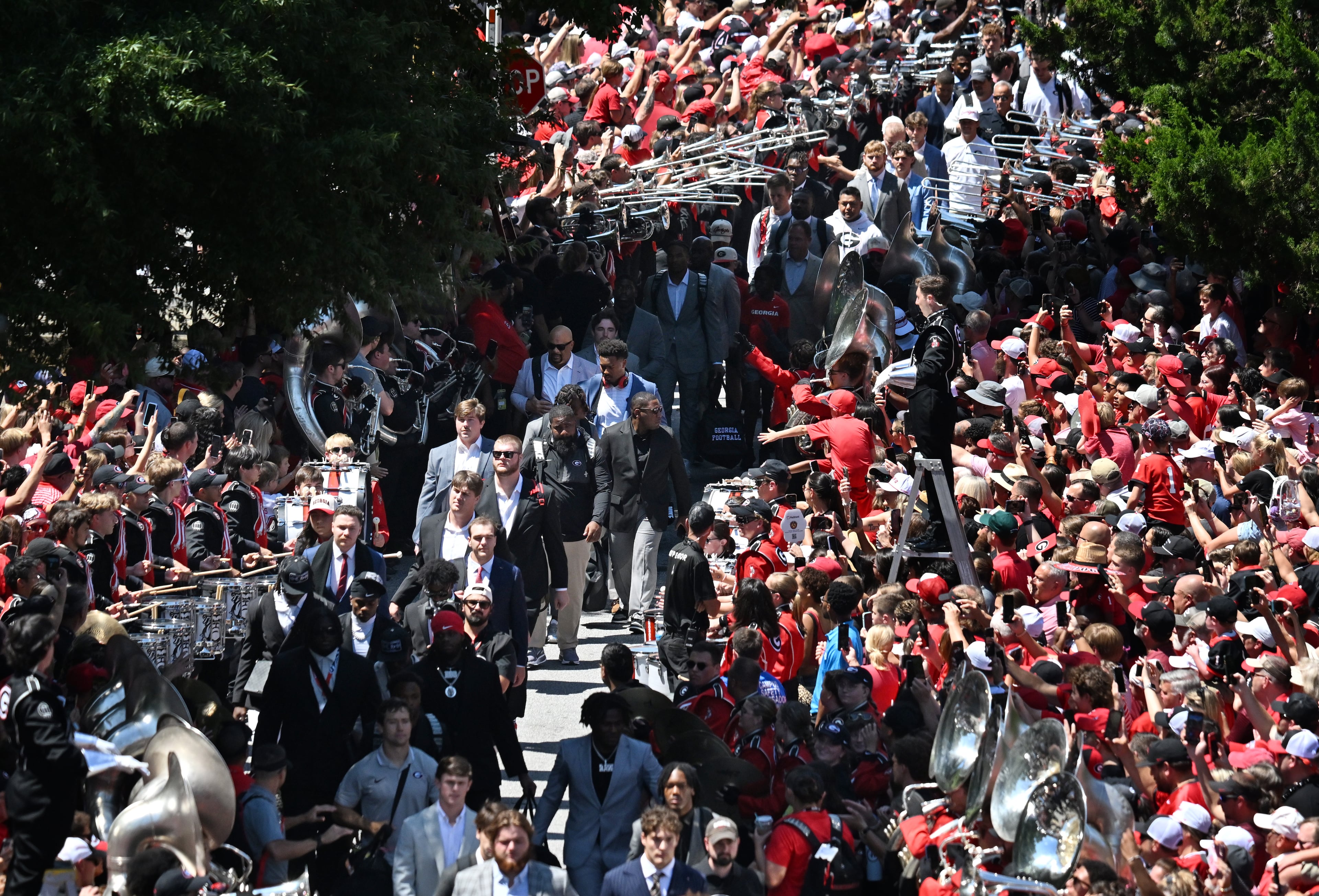 Georgia fans cheer as players and staff arrive during Dawgs Walk before Georgia football's season opener and home opener against Marshall at Sanford Stadium, Saturday, August 30, 2025, in Athens. (Hyosub Shin / AJC)