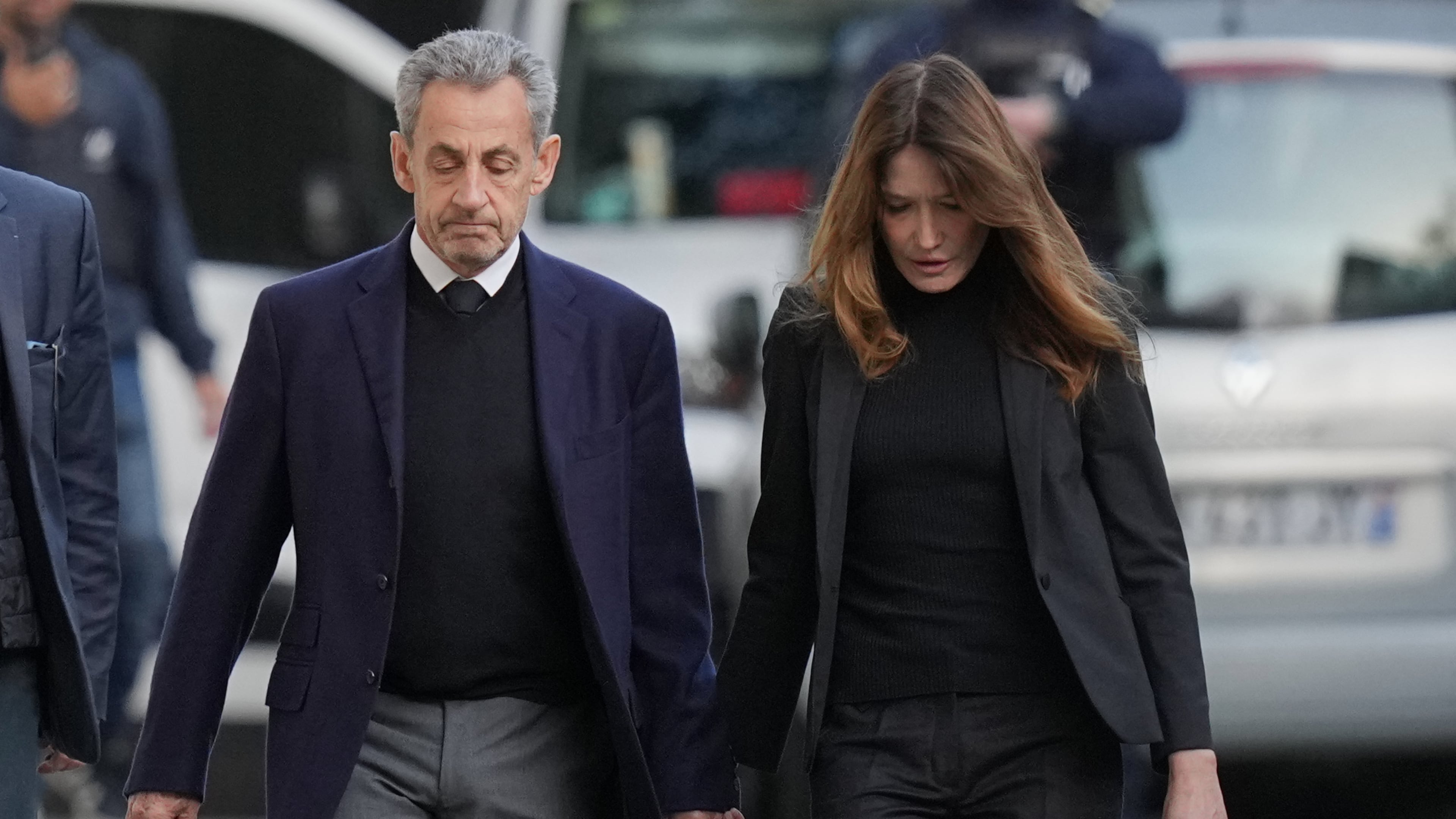 Former French President Nicolas Sarkozy and his wife Carla Bruni-Sarkozy leave their home Tuesday, Oct. 21, 2025 in Paris as Nicolas Sarkozy heads to prison to serve time for a criminal conspiracy to finance his 2007 election campaign with funds from Libya. (AP Photo/Thibault Camus)