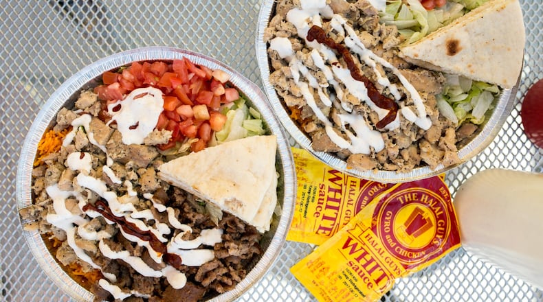 Beef Gyro Platter (left) and Chicken Platter (right) with toppings, special white sauce, and hot sauce. Photo credit- Mia Yakel.