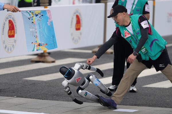 A robot loses control at the start in what is billed as the world's first robot half marathon during the Humanoid Robot Half-Marathon held in Beijing on Saturday, April 19, 2025. (AP Photo/Ng Han Guan)
