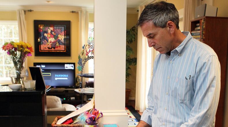 Larry Schweber is able to watch TV shows remotely through his iPad, turn on his alarm system, view video camera angles, or turn on lights from his smartphone as part of the monitoring system at his Atlanta home.