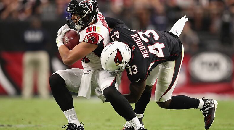 Falcons tight end Austin Hooper makes a reception against Cardinals' outside linebacker Haason Reddick during the second half Oct. 13, 2019, at State Farm Stadium in Glendale, Ariz.