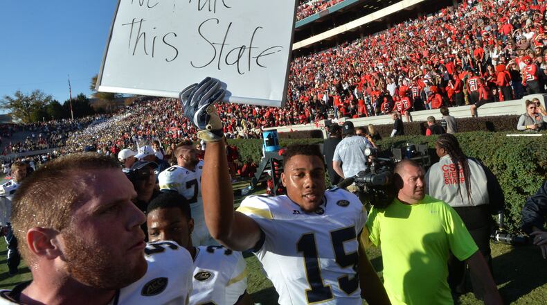 November 26, 2016 Athens - Georgia Tech defensive back A.J. Gray (15) holds a sign to celebrate their 28-27 win over Georgia at Sanford Stadium on Saturday, November 26, 2016. HYOSUB SHIN / HSHIN@AJC.COM