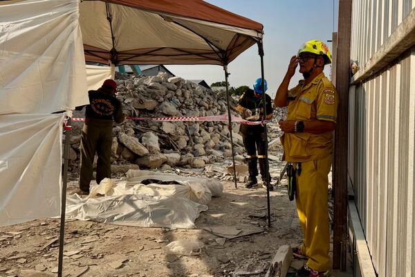 The bodies of victims of a high-rise building under construction that collapsed after a 7.7 magnitude earthquake lie on the ground in Bangkok, Thailand, Friday, March 28, 2025. (AP Photo/Wason Wanichakorn)