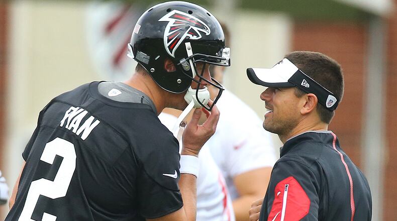 Falcons quarterbacks coach Matt LaFleur confers with Matt Ryan during a team practice in 2015. (Curtis Compton/AJC)