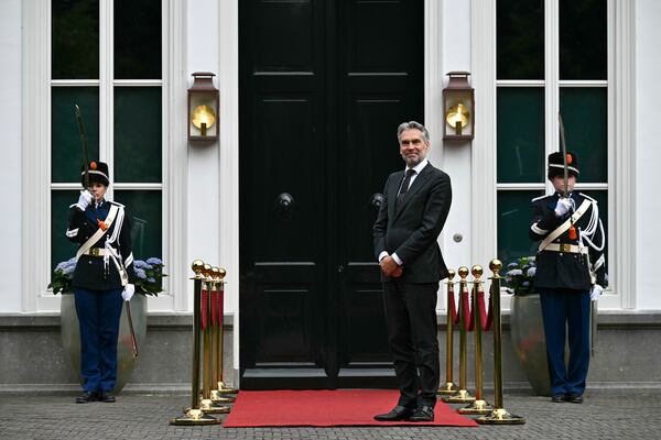 Netherlands' Prime Minister Dick Schoof, right, waits to welcome Britain's Prime Minister Keir Starmer during their meeting on the sidelines of a North Atlantic Treaty Organization (NATO) Heads of State and Government summit in The Hague, Tuesday, June 24, 2025. (Ben Stansall/Pool Photo via AP)