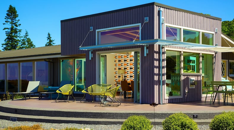 The new curved patio outside the addition is made of concrete, with porcelain tiles that extend from the kitchen area. What I like is it s just such a simple addition; the whole curve of patio serves to anchor the house, says architect Curtis McGuire. At nighttime, it s super-pretty. (Steve Ringman/Seattle Times/TNS)