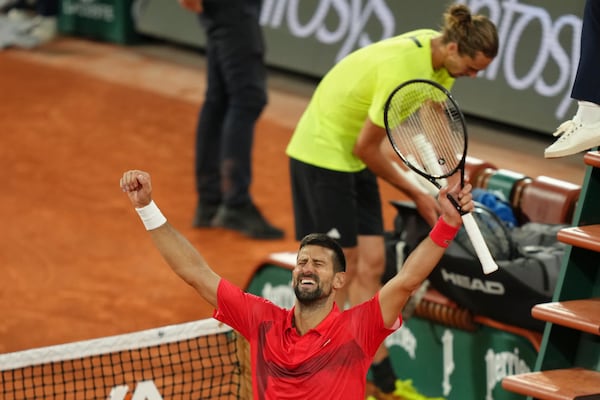 Serbia's Novak Djokovic celebrates as he won the quarterfinal match of the French Tennis Open against Germany's Alexander Zverev at the Roland-Garros stadium in Paris, Wednesday, June 4, 2025. (AP Photo/Aurelien Morissard)