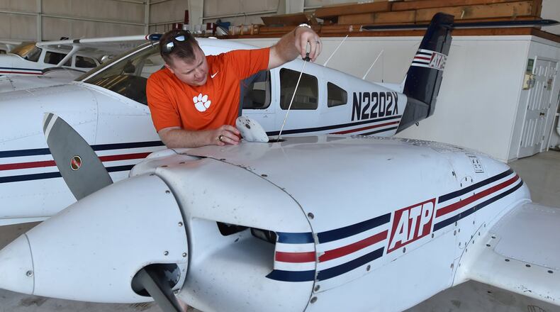 Cass Wood, a student at ATP Flight School, pre-flights an airplane at the Gwinnett County Airport.
