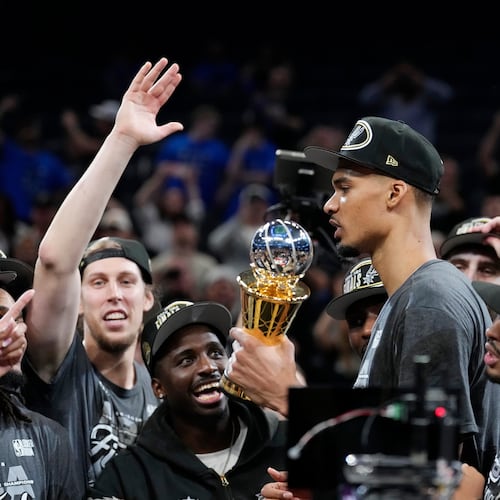 San Antonio Spurs forward Victor Wembanyama holds the MVP trophy as he celebrates with teammates after Game 7 of the Western Conference finals of the NBA basketball playoffs series win against the Oklahoma City Thunder, Saturday, May 30, 2026, in Oklahoma City. (AP Photo/Tony Gutierrez)