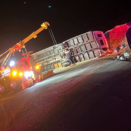 This photo provided by Mario Sanchez shows a bus that was carrying teens and young adults returning from a church camp overturned after it lost control and tipped onto its side on a two-lane highway Sunday, Nov. 9, 2025, near Running Springs, Calif. (Mario Sanchez via AP)