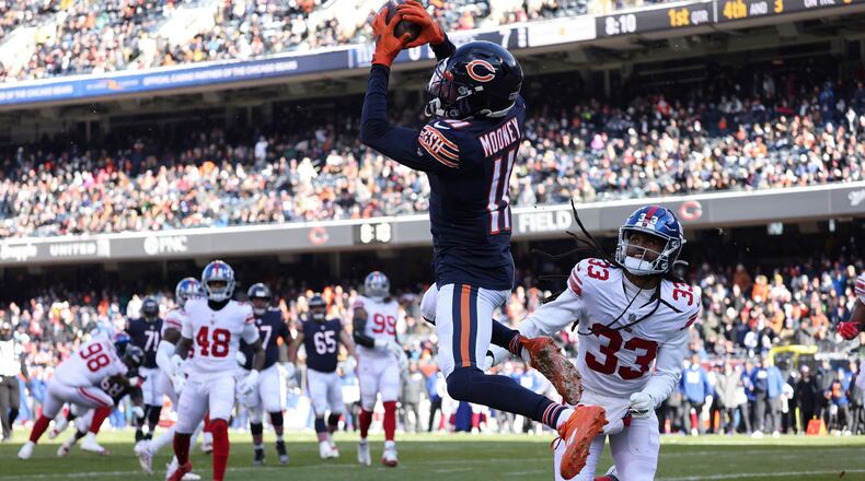 Chicago Bears wide receiver Darnell Mooney (11) makes a touchdown reception against New York Giants cornerback Aaron Robinson (33) in the first quarter, Jan. 2, 2022, at Soldier Field. (Brian Cassella/Chicago Tribune/TNS)