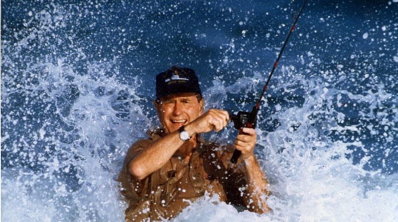 November 1988: President-elect George Bush fishes in a strong surf off the Gulf Stream during his vacation at the home of William Farish immediately following the election. (Allen Eyestone / The Palm Beach Post)