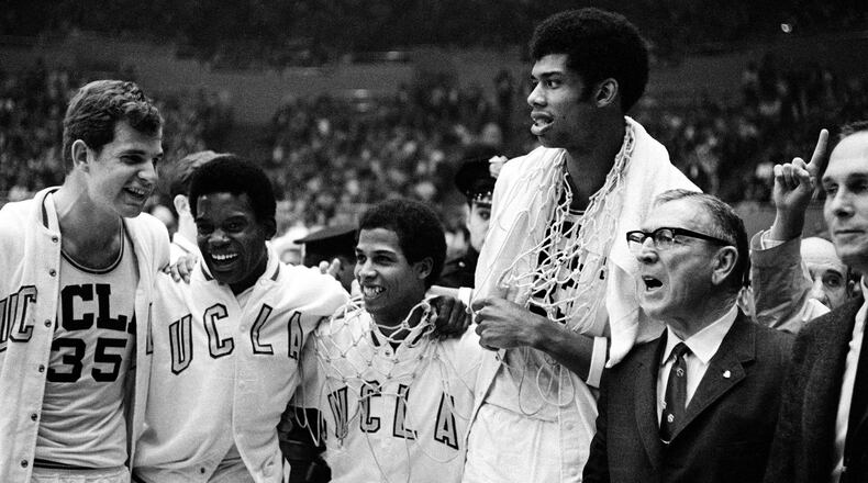 UCLA coach John Wooden, right, wearing eyeglasses, celebrates with his players, from left, Mike Lynn, Lucius Allen, Mike Warren and Lew Alcindor after the Bruins beat North Carolina, 78-55, to win the NCAA championship final at the Los Angeles Sports Arena, Ca., March 23, 1968. It is the second straight national collegiate basketball title for the Bruins. (AP Photo)
