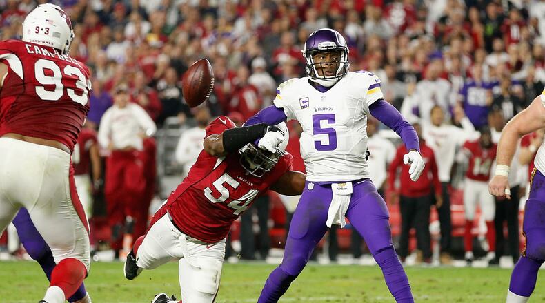 Quarterback Teddy Bridgewater of the Minnesota Vikings has the ball knocked free by linebacker Dwight Freeney, then of Arizona, last season. Freeney signed with the Falcons Tuesday. (Christian Petersen/Getty Images)